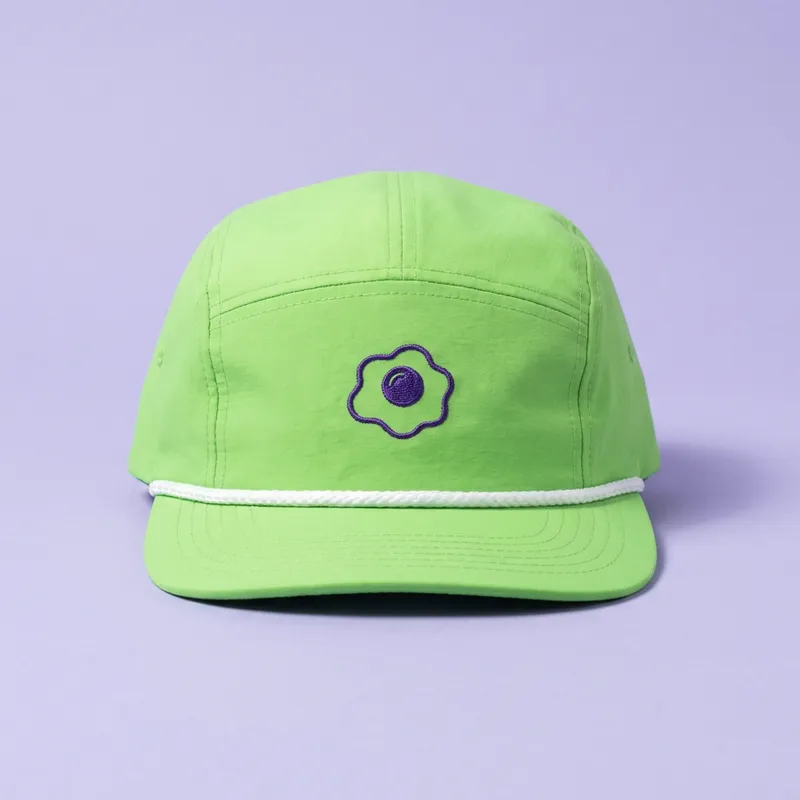 The rope cap: lime five-panel, white rope brim, the egg stitched on the front.